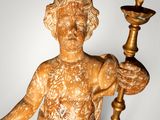 a statue of a woman holding a candle and a cup