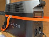 a black and orange blow dryer sitting on a wooden shelf