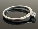 an image of a diamond ring on a black surface