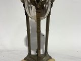 an antique brass and cut glass table lamp with a bird on it