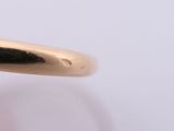 an image of a close up of a person ' s hand holding a gold ring with a diamond