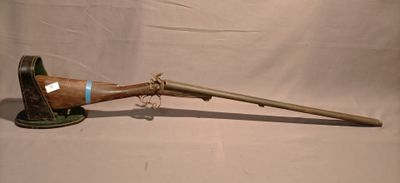 an old rifle with a wooden barrel and a wooden handle
