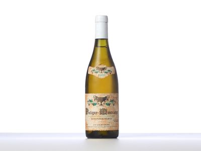a bottle of white wine sitting on top of a table