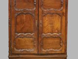 an old wooden armoire with carvings on the doors and drawers