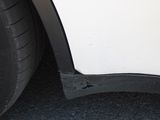 a close up of a white car with a hole in the side
