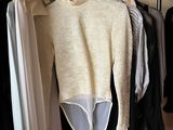 a rack of clothes hanging on a clothes rack in a closet