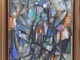 abstract painting of a cityscape in a gold frame on a wall