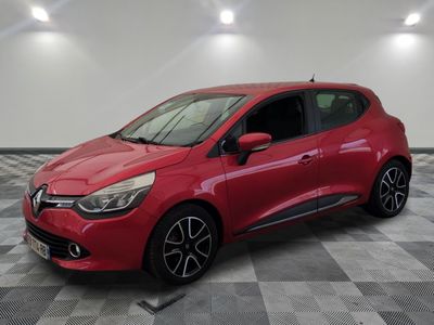 a red car parked in a garage with a checkered floor
