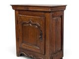 an old wooden cabinet with a door and a drawer underneath it