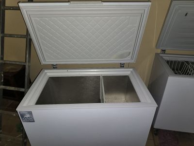 a white chest freezer sitting in a room