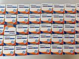 many boxes of toothpaste sitting on top of each other