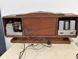 a wooden cabinet that has some electronics on top of it