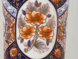 a vase with a floral design on it sitting on a table