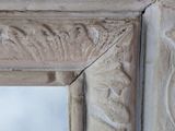 a close up of a mirror with a bird on it