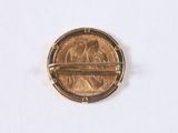 a coin with a bar on it sitting on a white surface