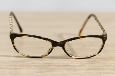 a pair of glasses sitting on a wooden table