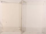 two empty glass cases sitting next to each other on the floor