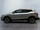 the silver nissan suv is parked in a white room