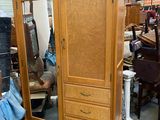 a wooden armoire with a mirror on top of it