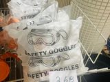 bags of safety goggles on a wire rack in a store