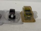three small plastic cars sitting on top of each other