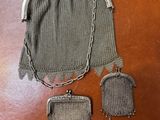 an old purse with a chain around it sitting on top of a table