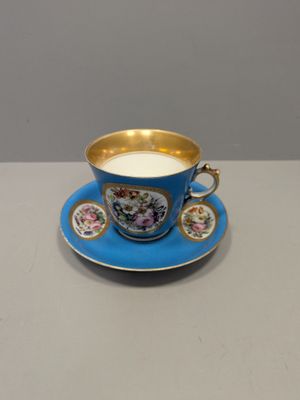 a close up of a cup and saucer on a table
