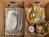 a cardboard box with some gold items inside of it