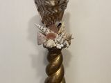 a vase that has shells in it on a table