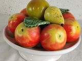 a bowl of apples and pears on a table