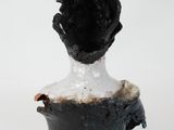 a black and white sculpture of a man with a hat on