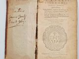 an old book with writing on it sitting on top of a table