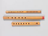 three flutes are lined up on a white surface