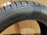 a close up of a tire on a cardboard box with a sticker on it