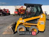 a picture of a yellow ski - loader parked in a parking lot