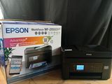 the printer is sitting next to the box on the table