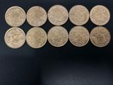 six different types of coins are shown on a black surface