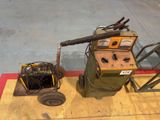 a machine that is sitting on the floor next to a cart