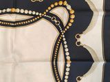 an image of a square scarf with beads on it