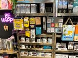 a display of various items in a store with a neon sign