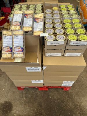 several boxes of food are stacked on a pallet in a store
