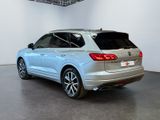 the rear end of a silver volkswagen suv parked in a garage