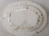 a dirty plate on the wall in the bathroom