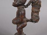 statue of a man with a hat on his head and a bag in his hand