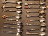 a lot of spoons that are on the wall