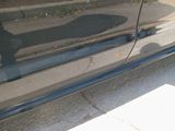 a black car parked on the side of the street