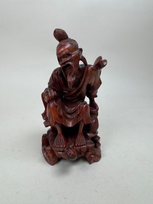 an image of a statue of a man with a goat on a rock