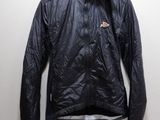 the jacket is hanging on a hanger in the corner of the room