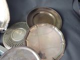 a lot of silver plates that are on a table