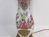 a lamp that is sitting on a table with a pink shade